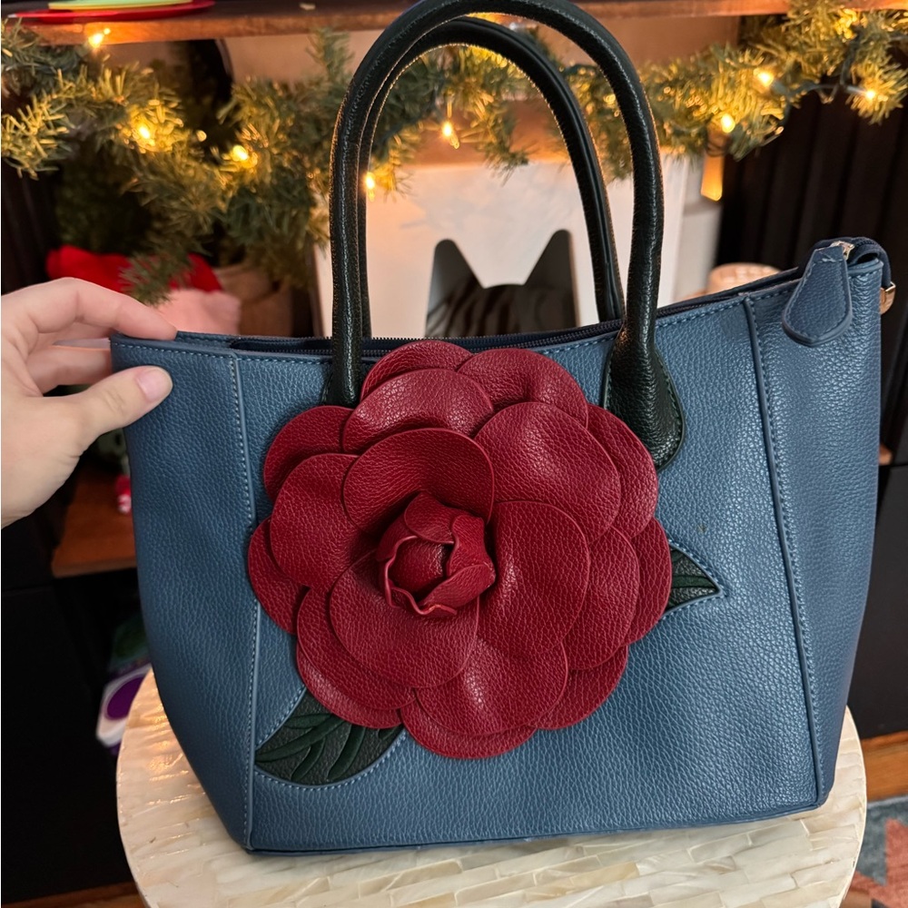 Elegant Blue Handbag with Red Floral Accent